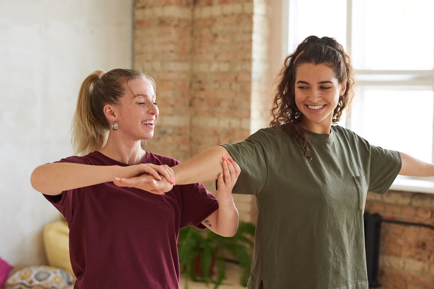 Happy young woman training with coach in health club